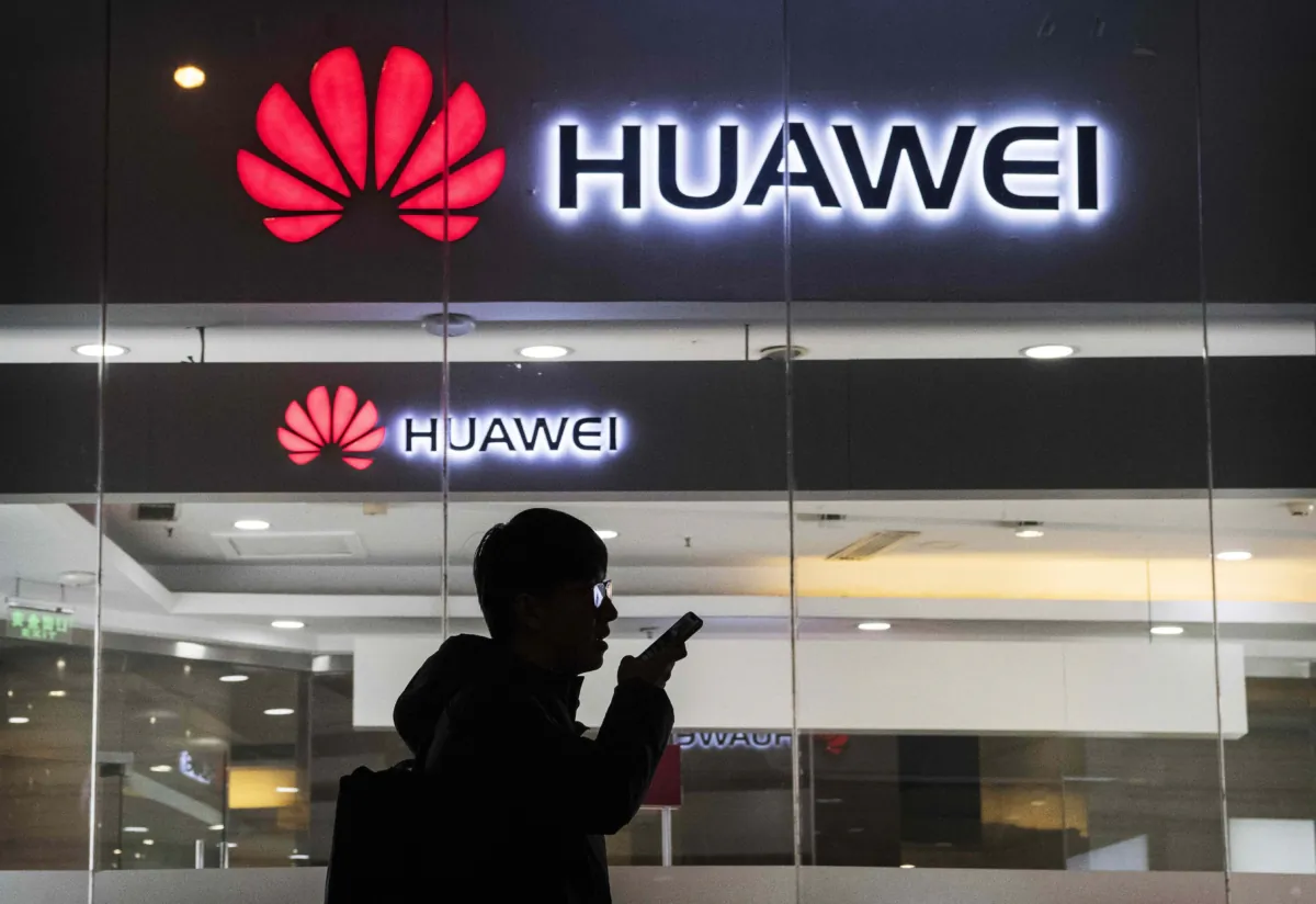 A pedestrian talks on the phone while walking past a Huawei Technologies Co. store in Beijing on Jan. 29, 2019. (Kevin Frayer/Getty Images)