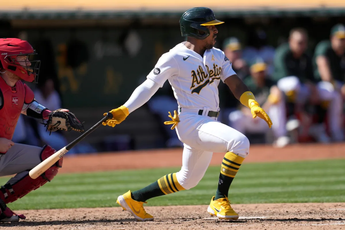 Oakland Athletics' Tony Kemp (R), watches his two-run single that scored Ryan Noda and Zack Gelof during the seventh inning of a baseball game against the Los Angeles Angels in Oakland, Calif., on Sept. 3, 2023. (Jeff Chiu/AP Photo)