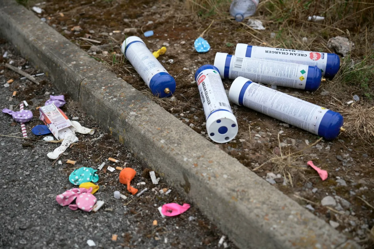 NORTHWICH, UNITED KINGDOM - JUNE 27: Empty nitrous oxide catering canisters, commonly known as laughing gas and balloons, used to inhale the gas, is discarded in a car park on June 27, 2023 in Northwich, United Kingdom. The UK govenrnment is considering banning nitrous oxide in the future as part of a government crackdown on anti-social behaviour (Photo by Christopher Furlong/Getty Images)
