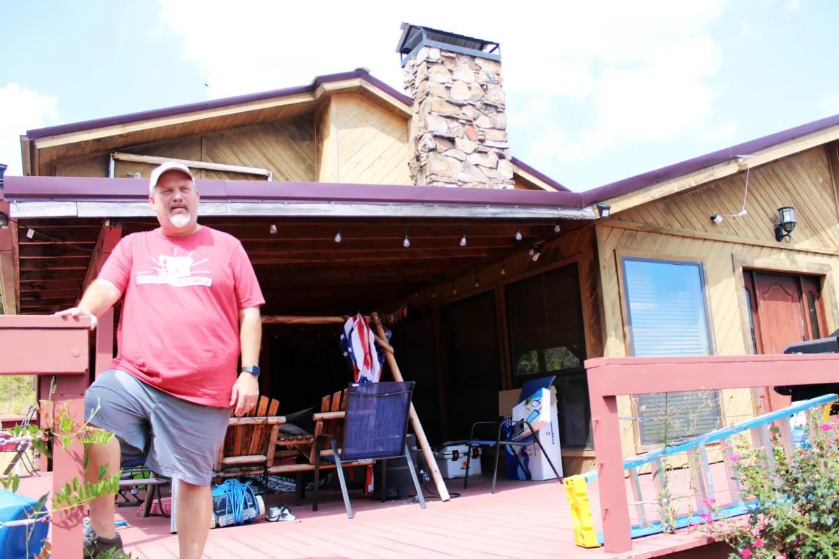 Russell Fincher stands on the porch of his home in Tuskahoma, Okla., on Sept. 1, 2023. Mr. Fincher claims armed ATF agents raided his home and forced him to relinquish his Federal Firearms License and confiscated 50 of his legally-owned firearms. (Michael Clements/The Epoch Times)