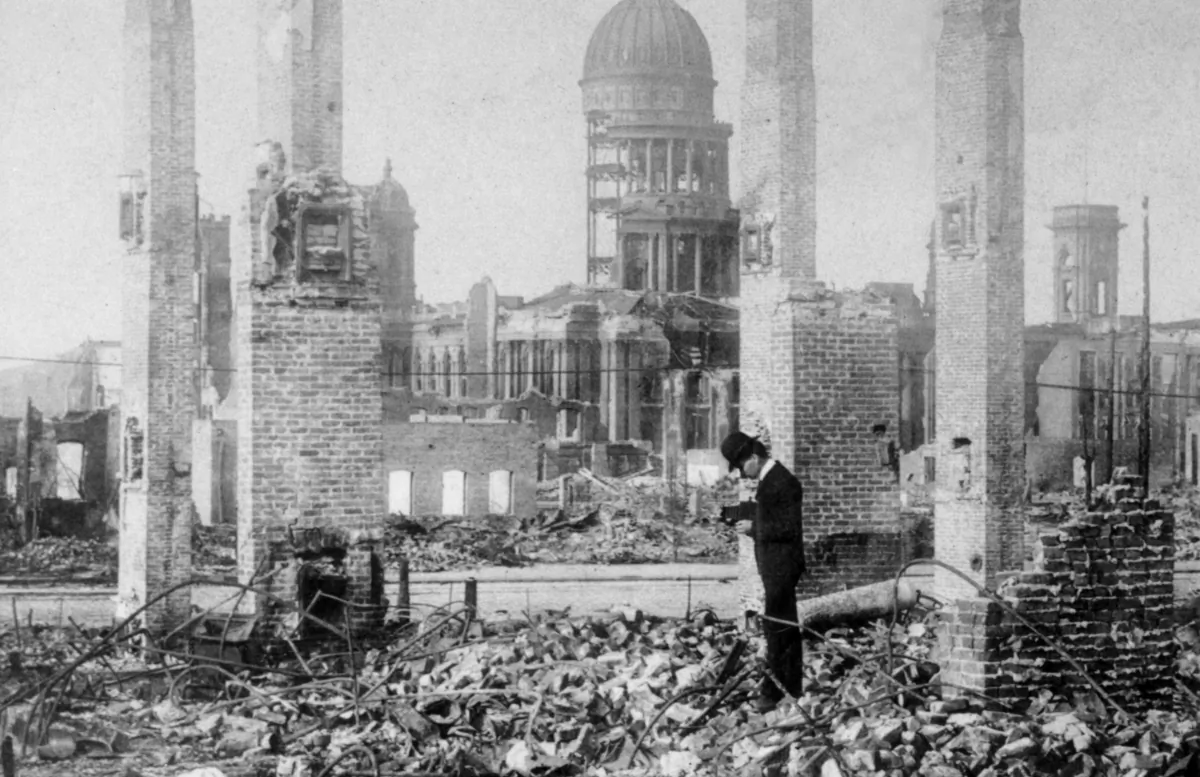 A man photographs the ruins of a building block in front of the remains of City Hall after the San Francisco earthquake of April 18, 1906. (Hulton Archive/Getty Images)