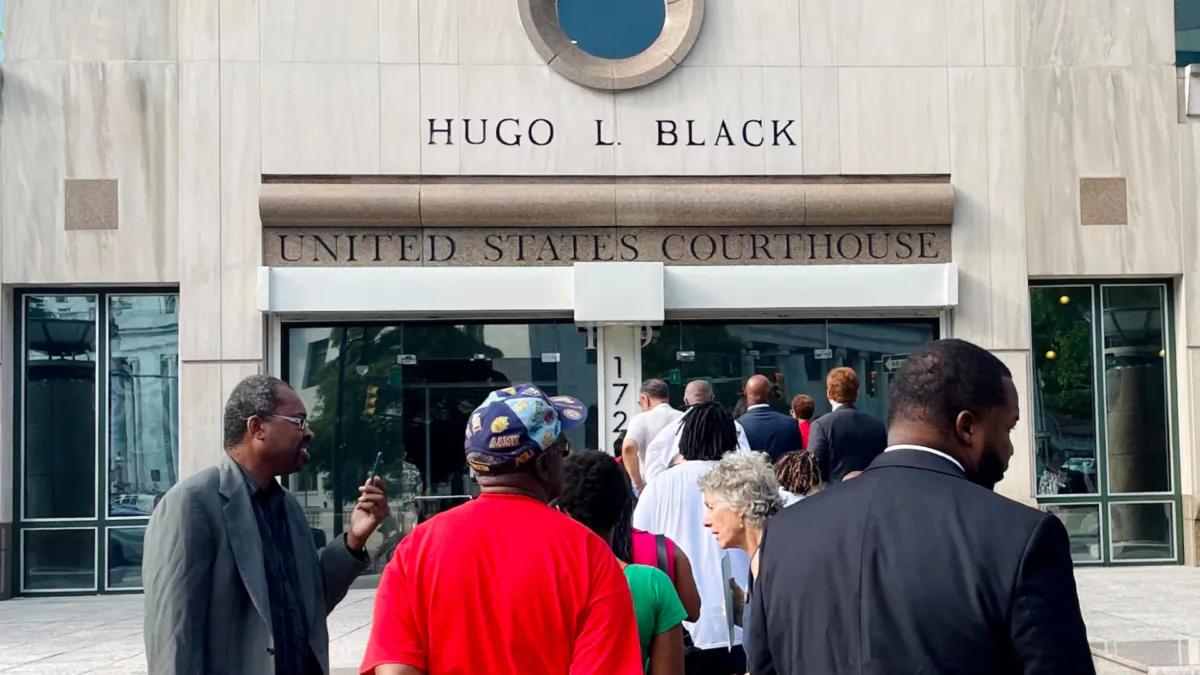 A line of people wait outside the federal courthouse in Birmingham, Ala., on Aug. 14, 2023, to watch a redistricting hearing. (Kim Chandler/AP Photo)