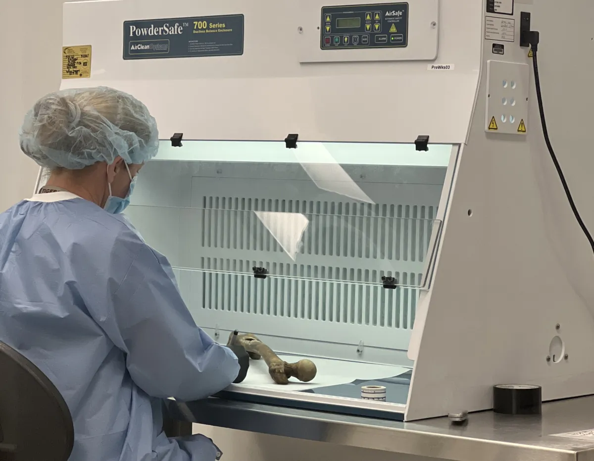 An employee of Othram works with human remains at a lab in The Woodlands, Texas. (Courtesy of Othram, Inc.)
