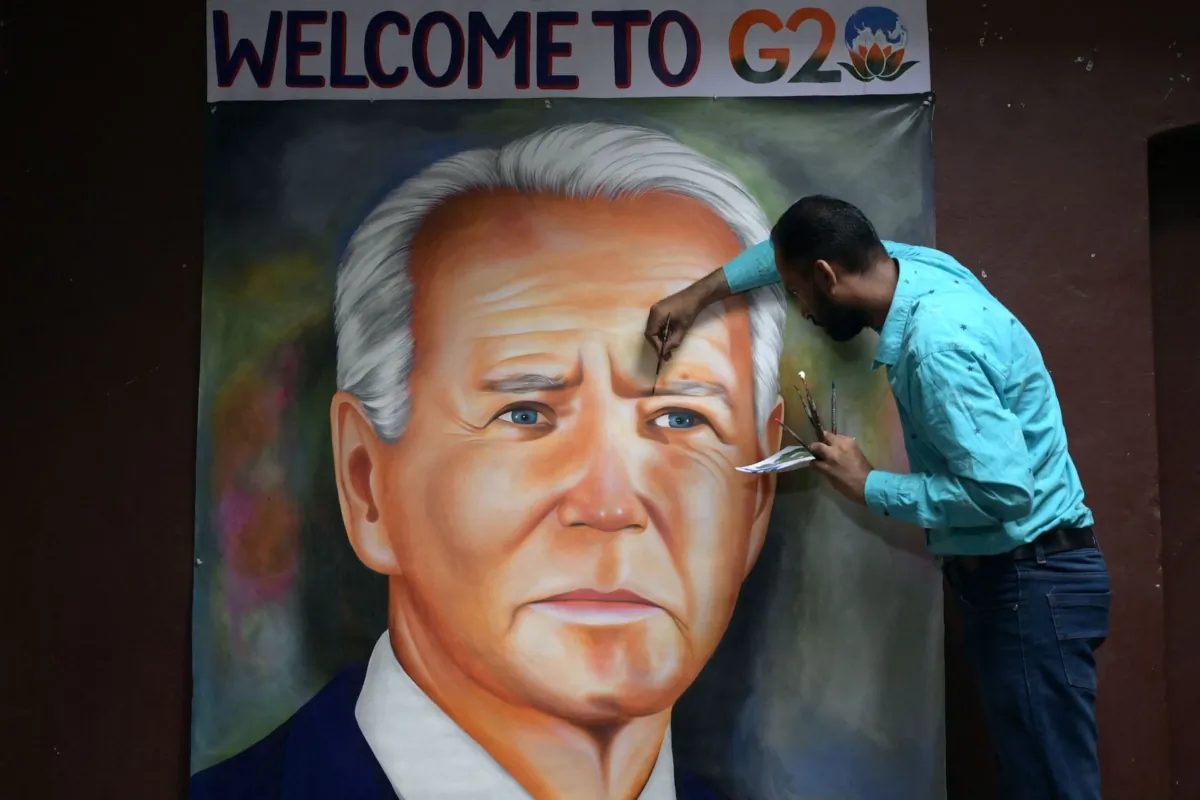 Indian artist Jagjot Singh Rubal puts final touches on an oil painting of U.S. President Joe Biden, at his workshop in Amritsar, India, on Sept. 5, 2023, ahead of the two-day G20 summit in New Delhi. (Narinder Nanu/AFP via Getty Images)