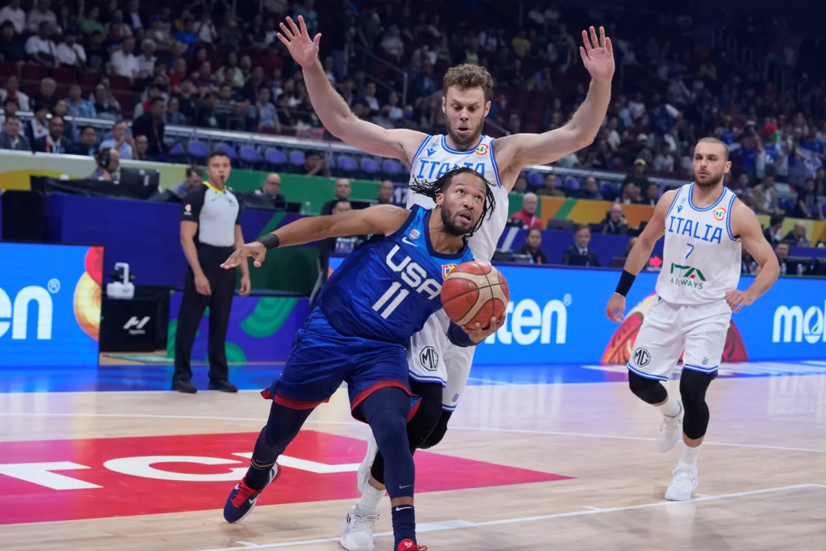 U.S. guard Jalen Brunson (11) drives against Italy forward Nicolo Melli (9) during the Basketball World Cup quarterfinal game between Italy and U.S. at the Mall of Asia Arena in Manila, Philippines, on Sept. 5, 2023. (Michael Conroy/AP Photo)
