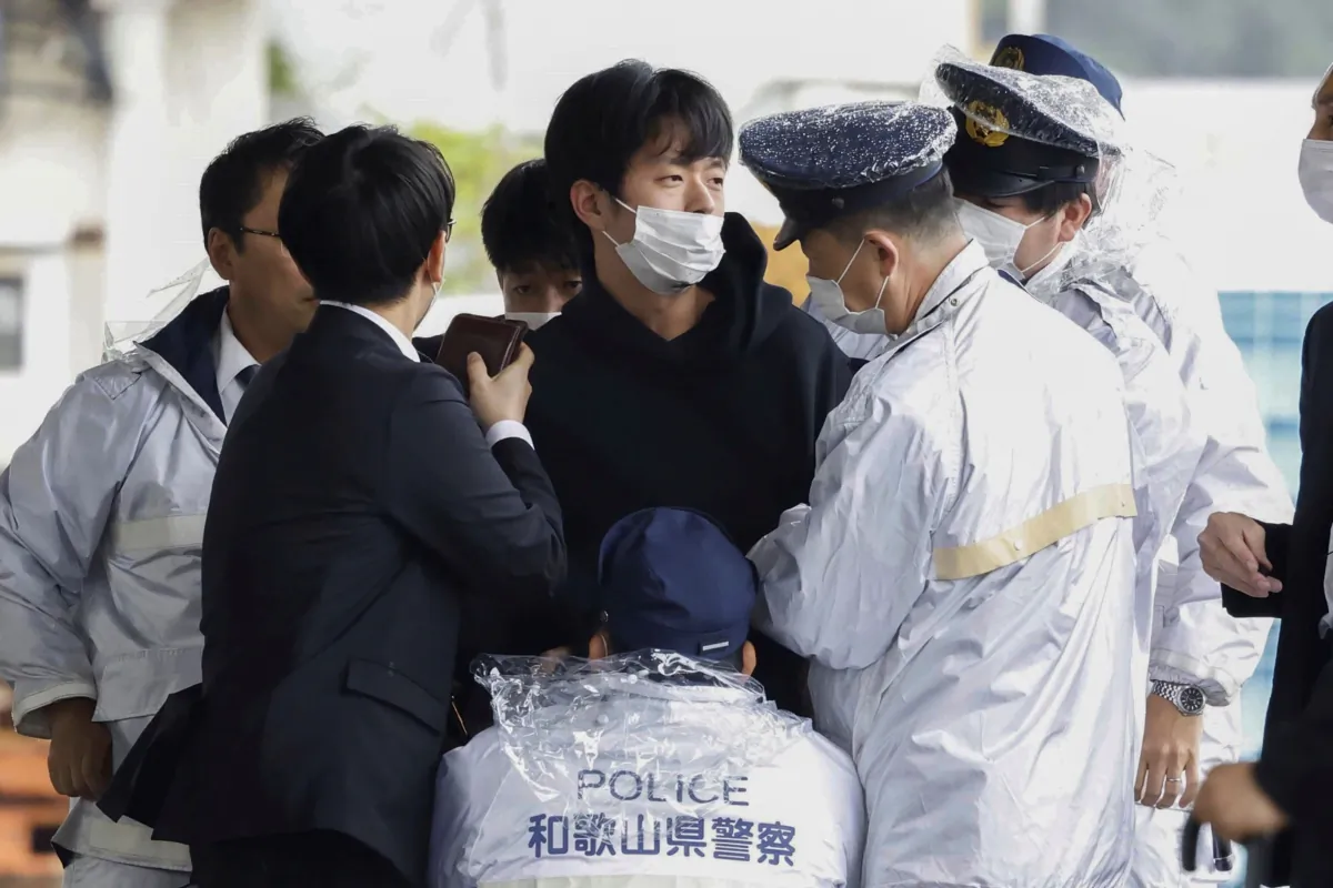A man who was later identified as Ryuji Kimura is arrested after what appeared to be a pipe bomb was thrown at Japanese Prime Minister Fumio Kishida during his visit at a port in Wakayama, western Japan, on April 15, 2023. (Kyodo News via AP)