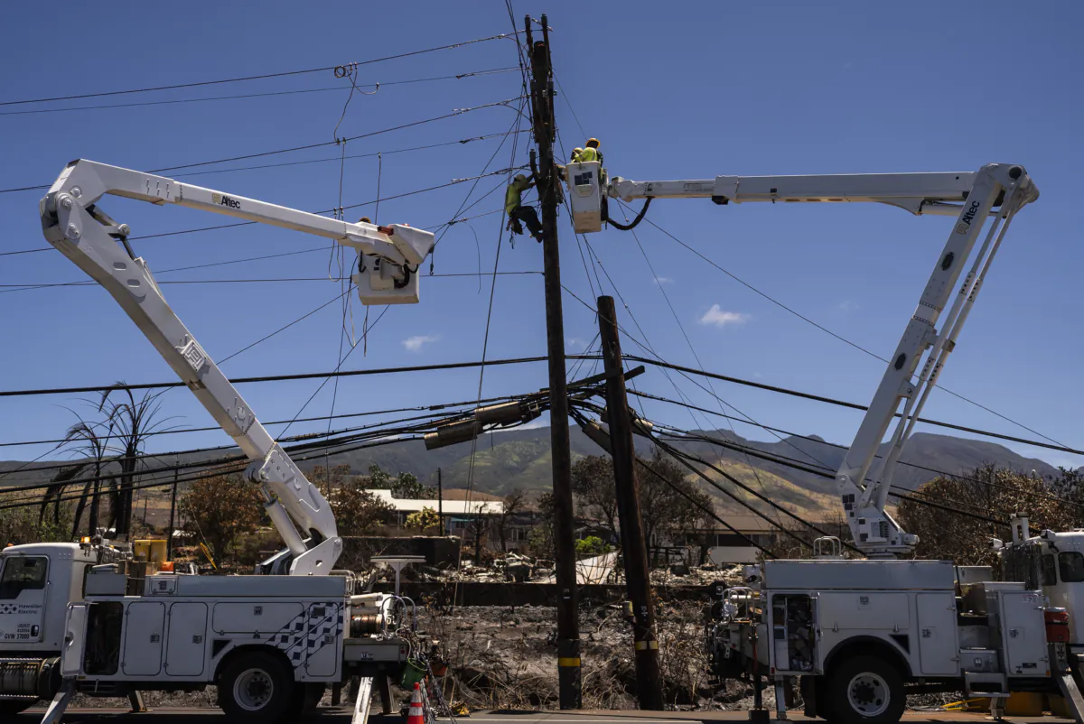 Electric crews work on power lines in the aftermath of a devastating wildfire in Lahaina, Hawaii, on Aug. 17, 2023. (Jae C. Hong/AP Photo)