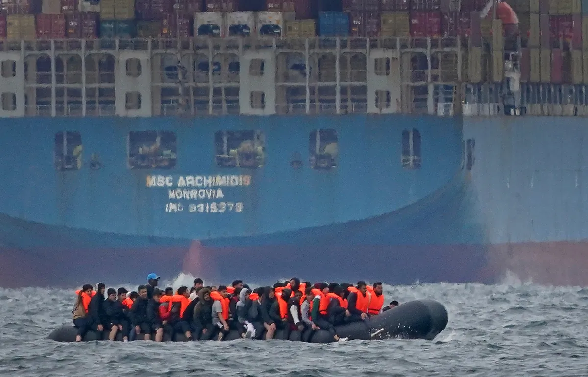 A group of people thought to be migrants crossing the English Channel in a small boat traveling from the coast of France and heading in the direction of Dover, Kent on Aug. 29, 2023. (PA Media)