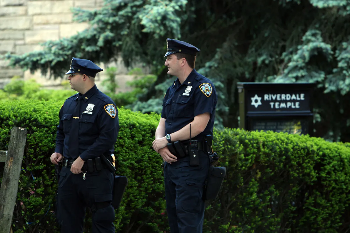 Police stand guard outside of Riverdale Temple following the apparent foiling of a terrorist plot in the Bronx borough of New York City on May 21, 2009. Four suspects were arrested on charges of plotting to detonate explosives near a synagogue and Jewish center in the Bronx borough of New York City and to shoot down military planes located at the New York Air National Guard Base at Stewart Airport in Newburgh, New York, after a year-long police and FBI sting supplied the suspects with inactive explosives and missile. (Spencer Platt/Getty Images)