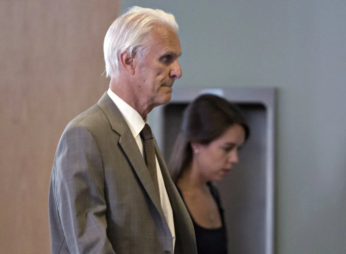 Quebec judge Jacques Delisle (L), walks into court with his granddaughter Anne Sophie Morency, in Quebec City on June 14, 2012. (The Canadian Press/Jacques Boissinot)