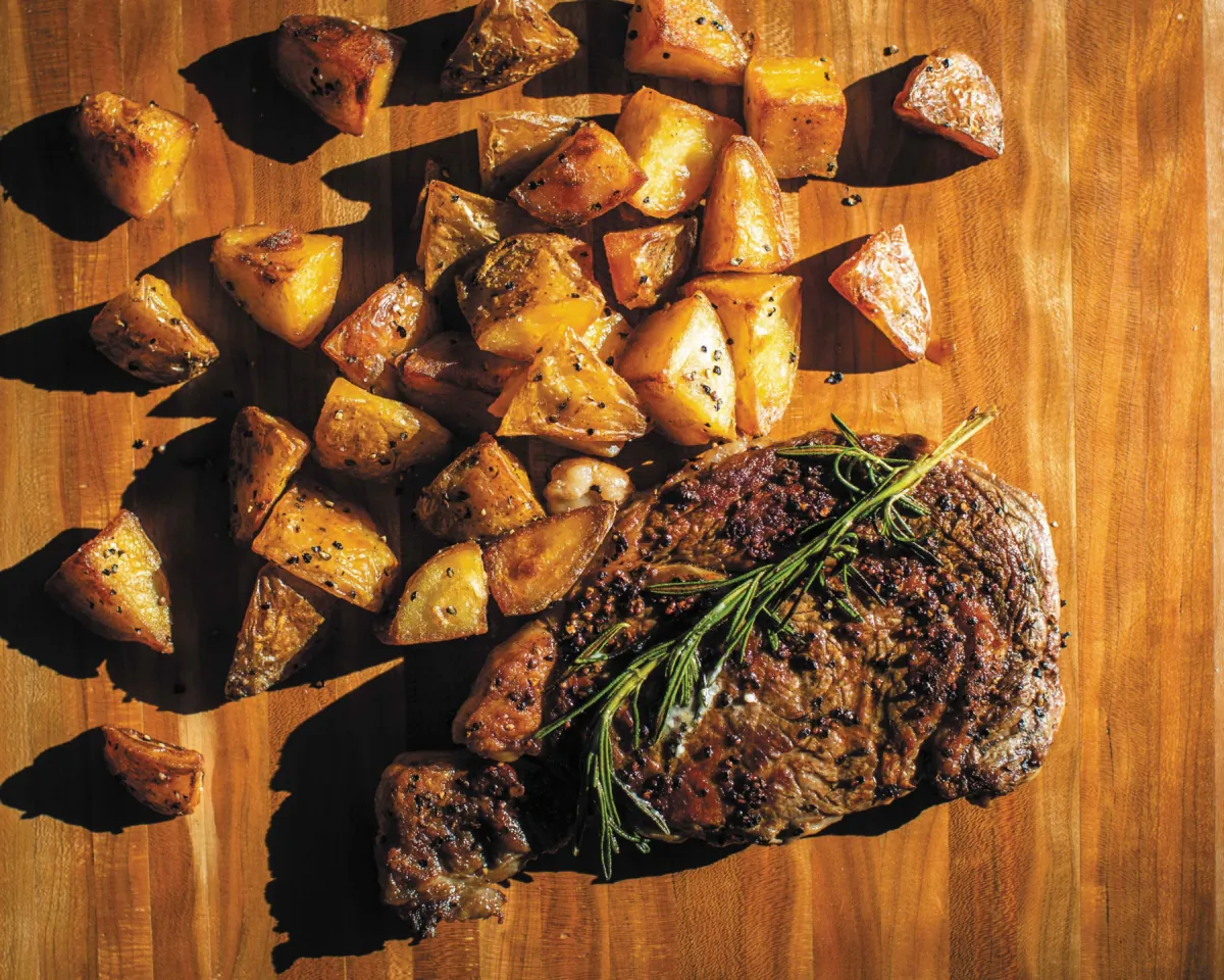 Seared ribeye with blue cheese butter and beef-fat potatoes. (Andrea Behrends) 