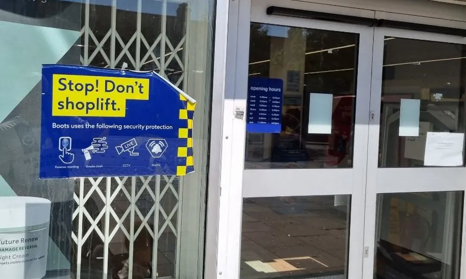 A sign warning shoplifters, outside a branch of Boots the chemist in west London on Sep. 5, 2023. (Chris Summers/The Epoch Times)