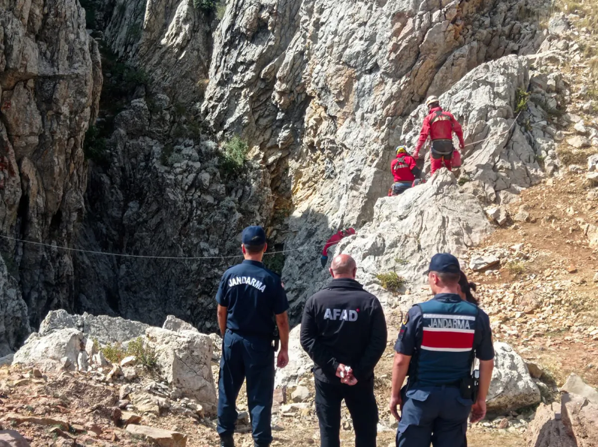 European Cave Rescue Association (ECRA) members and Turkish gendarmerie officers stand next to the entrance of Morca cave near Anamur, southern Turkey, on Sept. 7, 2023. (Mithat Unal/Dia Images via AP)