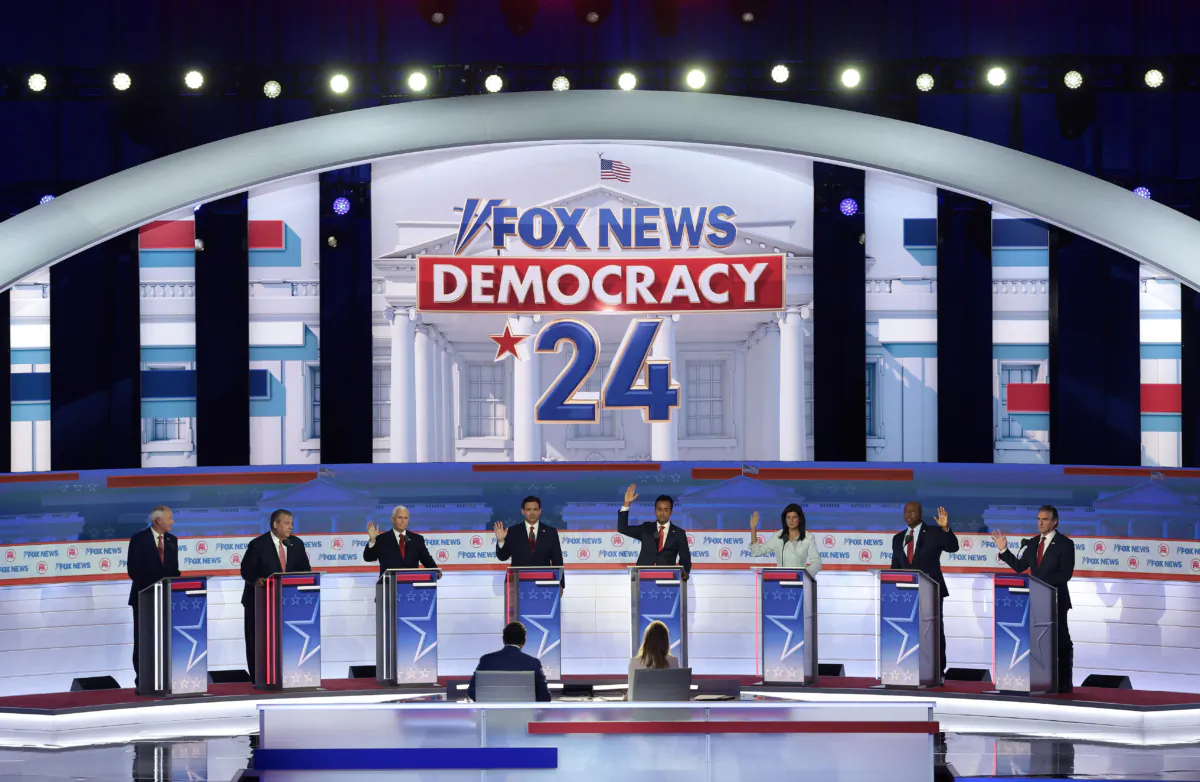 With the exception of former Arkansas Gov. Asa Hutchinson and former New Jersey Gov. Chris Christie, Republican presidential candidates (3rd L-R) former U.S. Vice President Mike Pence, Florida Gov. Ron DeSantis, Vivek Ramaswamy, former U.N. Ambassador Nikki Haley, U.S. Sen. Tim Scott (R-SC) and North Dakota governor Doug Burgum raise their hands to say they would support Donald Trump as the party's presidential nominee during the first debate of the GOP primary season hosted by FOX News at the Fiserv Forum in Milwaukee, Wis., on Aug. 23, 2023. (Win McNamee/Getty Images)