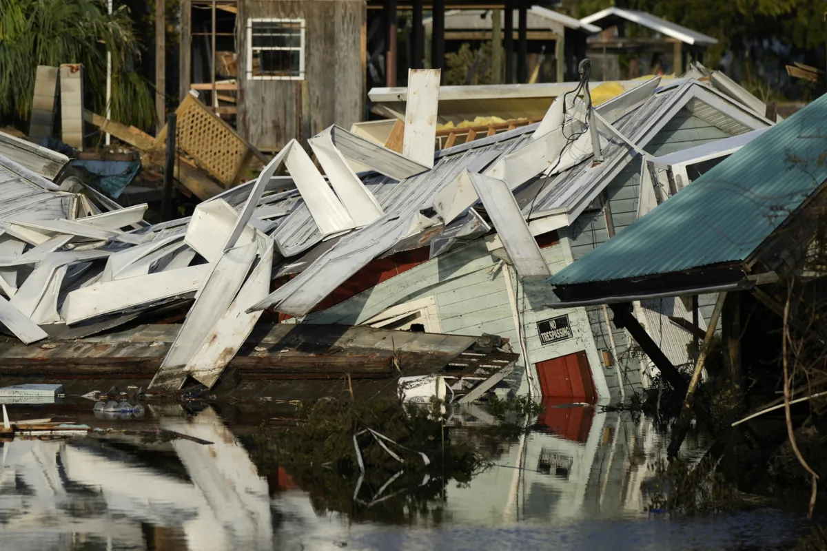 An unstilted home which came off its blocks sits partially submerged in a canal in Horseshoe Beach, Fla., on Sept. 1, 2023, two days after the passage of Hurricane Idalia. (Rebecca Blackwell/AP Photo)