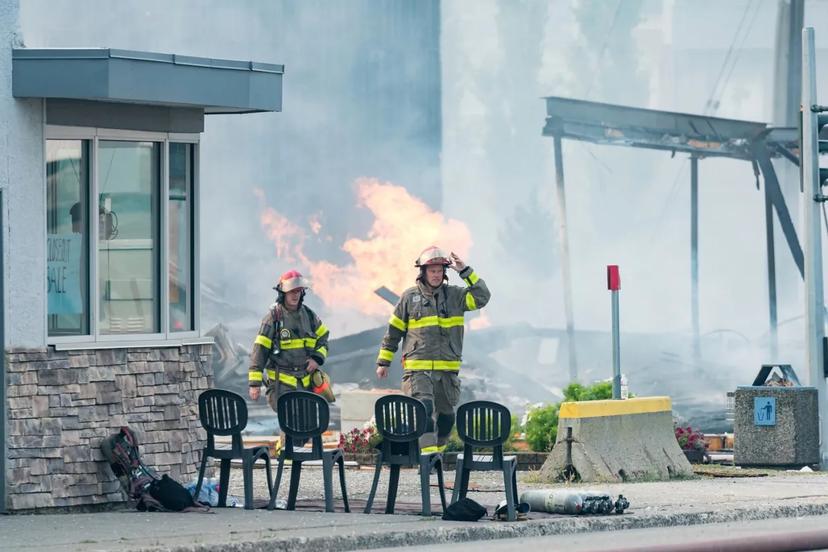 Prince George fire crews tend to a structure fire caused by an explosion in downtown Prince George, B.C., on Aug.
22, 2023. (The Canadian Press/James Doyle)