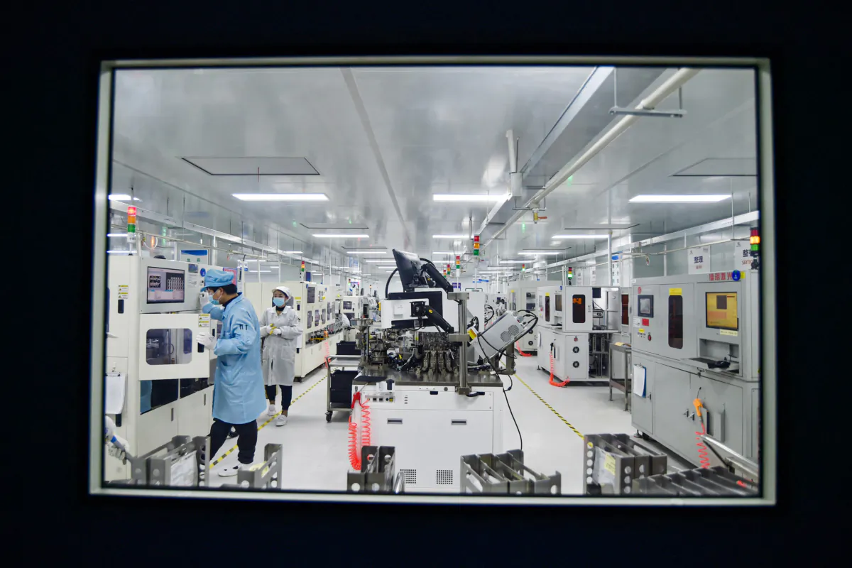 A worker produces a semiconductor chips at a workshop in Suqian, in China's eastern Jiangsu province, on Feb. 28, 2023. (STR/AFP via Getty Images)