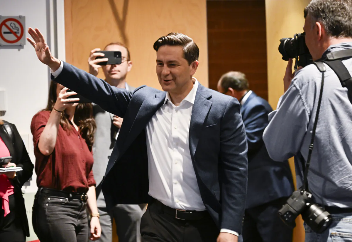 Conservative Leader Pierre Poilievre waves as he enters a caucus meeting prior to the Conservative convention, in Quebec City on Sept. 7, 2023. (The Canadian Press/Jacques Boissinot)