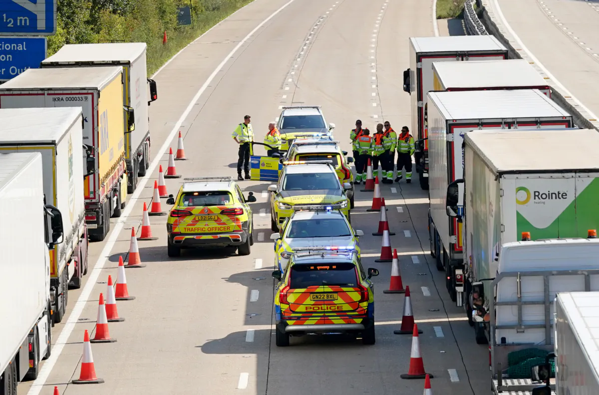 Police officers involved in the search for prison escapee Daniel Khalife check lorries on the southbound M20 near Ashford in Kent, England on Sep. 7, 2023. (Gareth Fuller/PA)