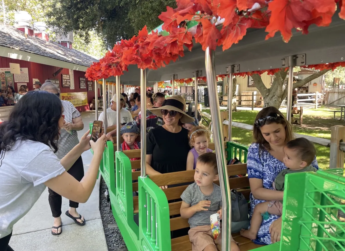 Visitors ride the Irvine Park Railroad's new electric train in Orange, Calif., on Sept. 7, 2023. (Carol Cassis/The Epoch Times)