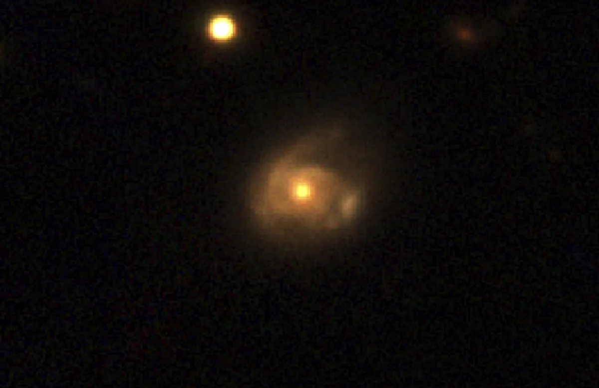 The interaction between a supermassive black hole in a galaxy named 2MASX J02301709+2836050 and a star orbiting it is seen in this image captured by the Pan-STARRS telescope in Hawaii in an undated handout image. (Neils Bohr Institute/Daniele Malesani/Handout via Reuters)
