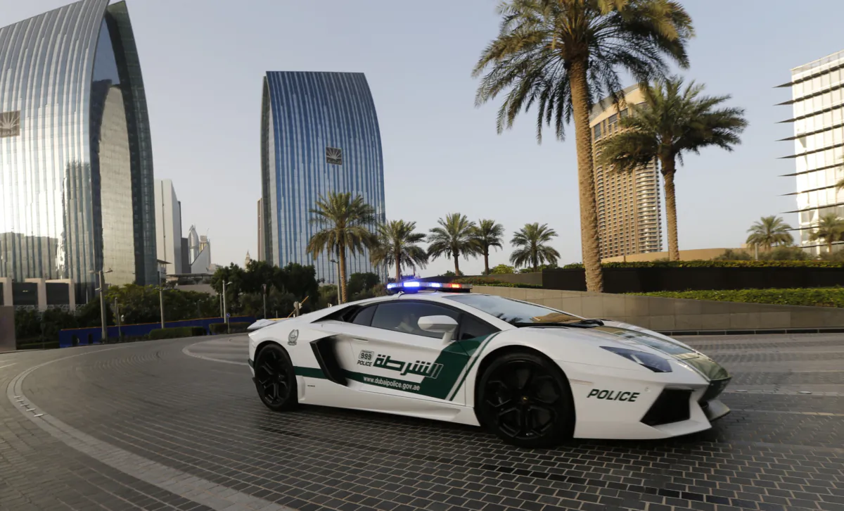 Emirati policemen patrol in an especially modified Lamborghini Aventador in the Gulf emirate of Dubai on April 16, 2013. (Karim Sahib/AFP via Getty Images)