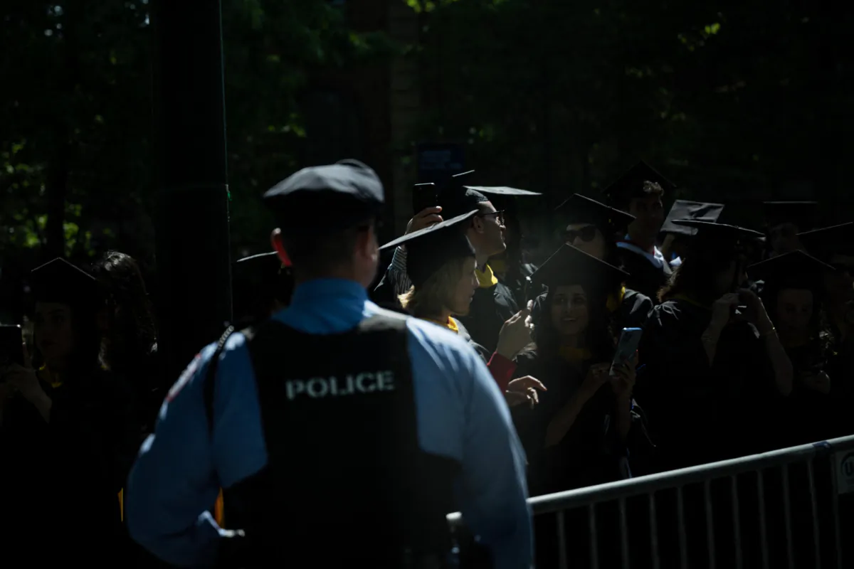 Students wait behind a police line as President Joe Biden arrives to attend his granddaughter Maisy Biden's graduation from the University of Pennsylvania at Franklin Field in Philadelphia on May 15, 2023. (Brendan Smialowski/AFP via Getty Images)
