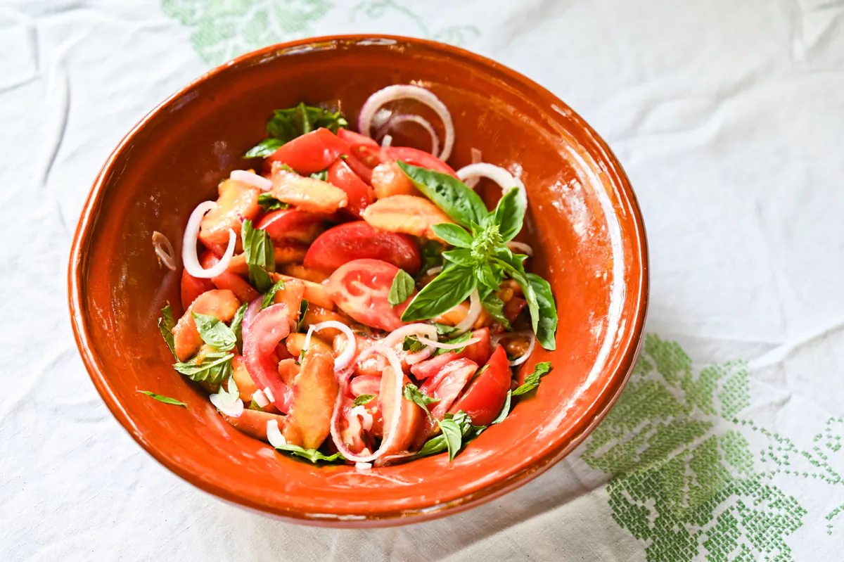 A peach and tomato salad made by Gretchen McKay on Friday, Aug. 11, 2023, in Ben Avon. (Teagan Staudenmeier/Pittsburgh Post-Gazette/TNS)