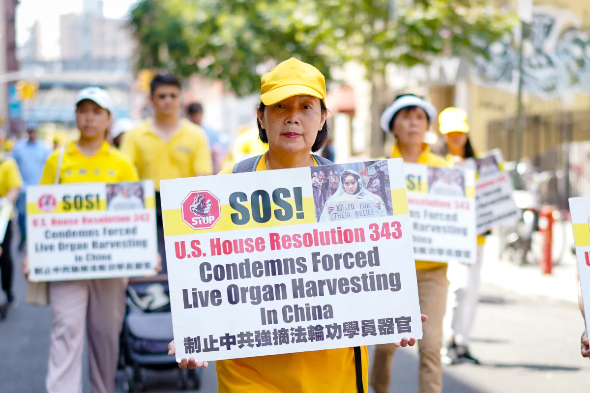 Falun Gong practitioners take part in a parade to commemorate the 24th anniversary of the persecution of the spiritual discipline in China, in New York's Chinatown on July 15, 2023. (Samira Bouaou/The Epoch Times)
