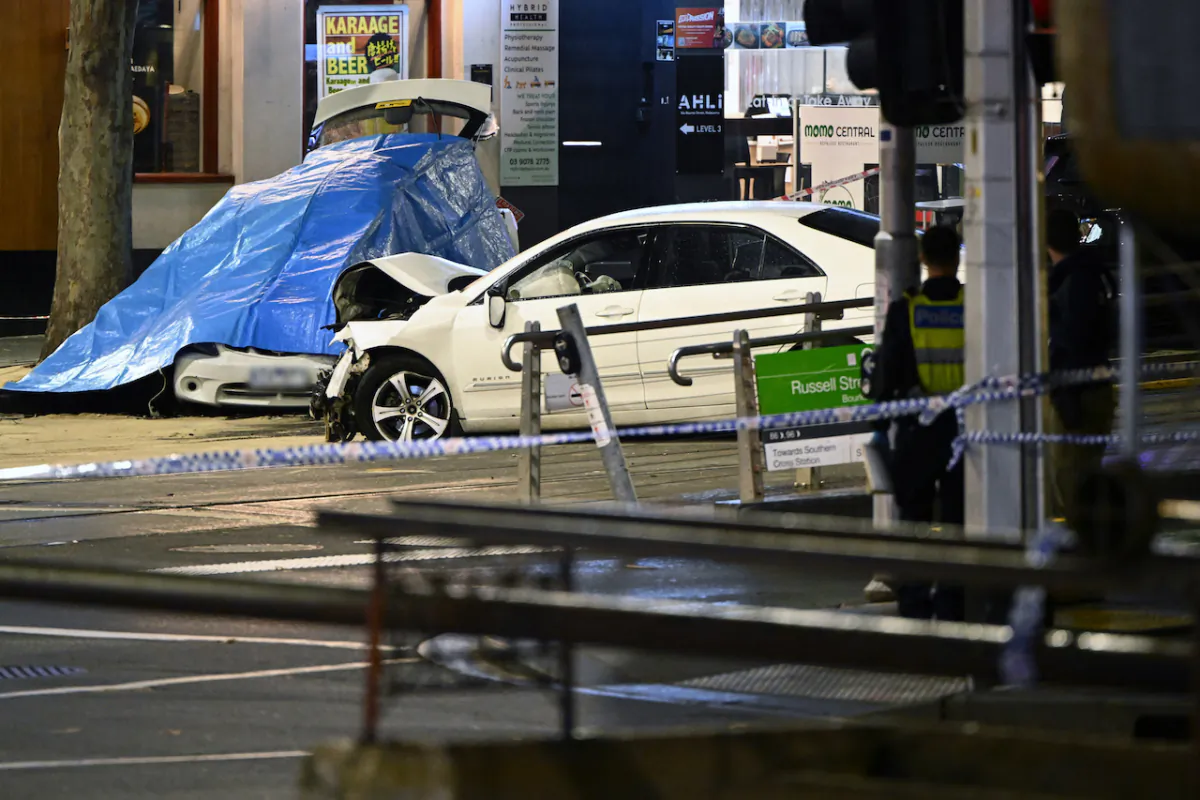 Victoria Police restrict access to the scene of a multi-vehicle incident involving pedestrians on the corner of Burke and Russell Streets in the central business district, Melbourne, Sept. 8, 2023. A car has smashed into several pedestrians in the Melbourne CBD before crashing into two other vehicles. (AAP Image/Joel Carrett)