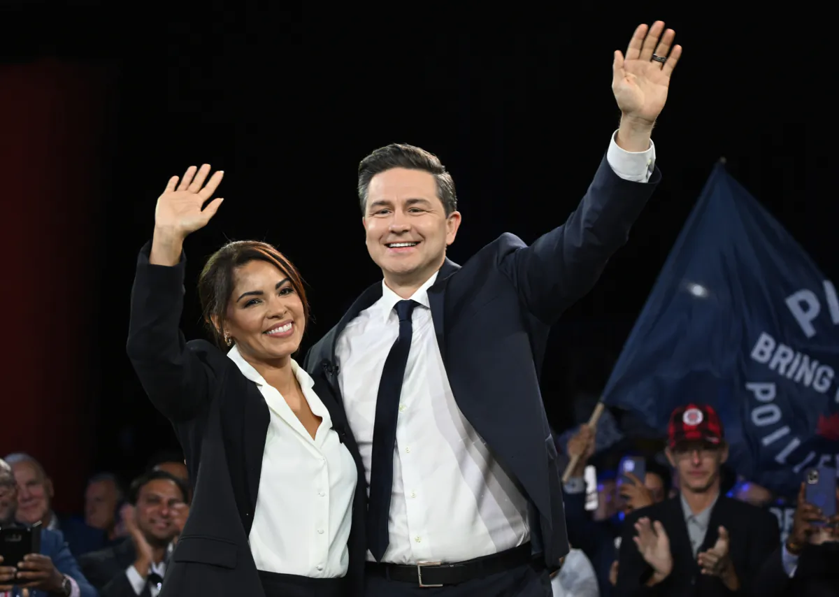 Conservative Leader Pierre Poilievre and his wife Anaida wave to delegates at the Conservative Party Convention in Quebec City on Sept. 8, 2023. (Jacques Boissinot/The Canadian Press)