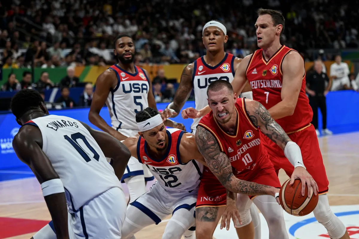 Germany's Daniel Theis (lower R)  holds the ball during the FIBA Basketball World Cup semi-final match between USA and Germany in Manila on September 8, 2023. (Jam Sta Rosa /AFP via Getty Images)