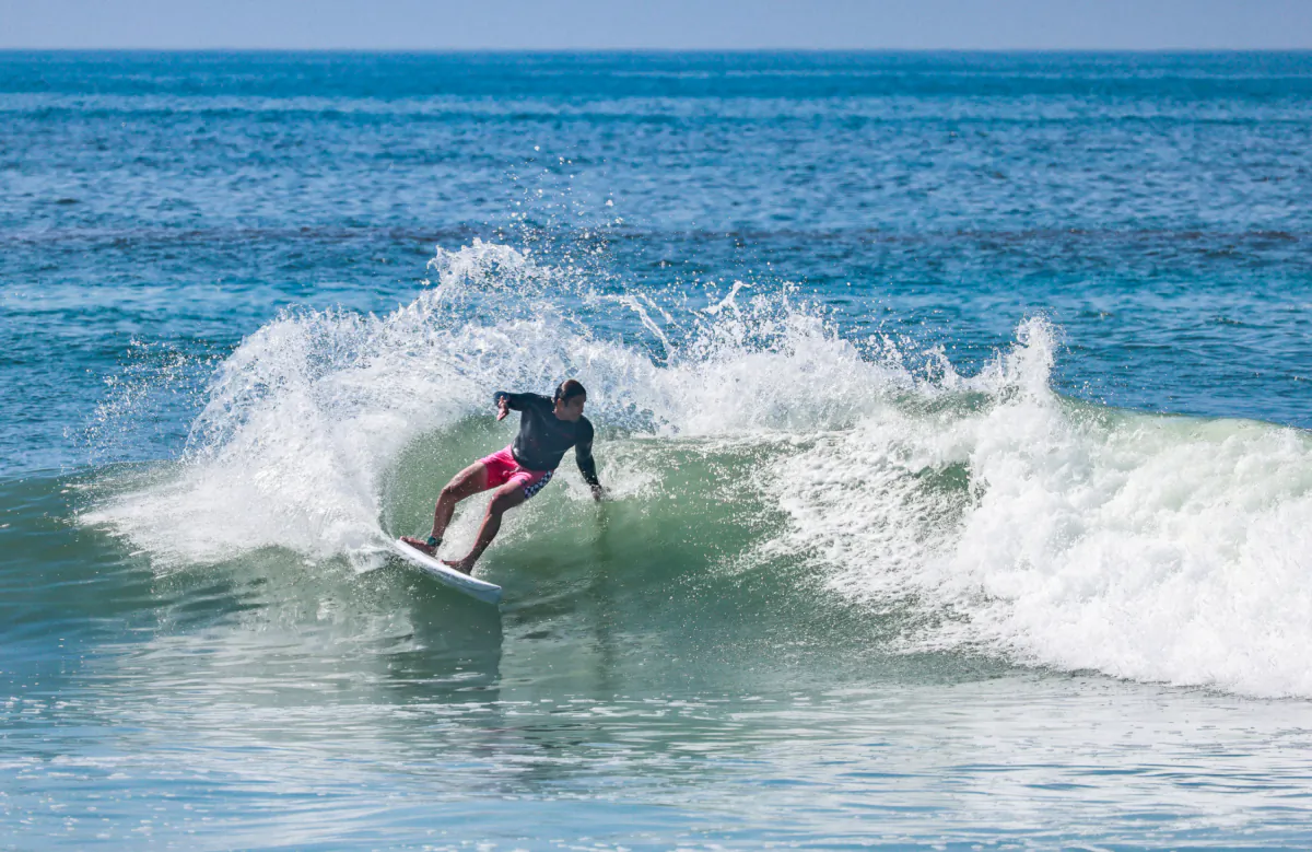 Surfers ride waves in front of the staging area of the Rip Curl WSL Finals of Lower Trestles in San Clemente, Calif., on Sept. 8, 2023. (John Fredricks/The Epoch Times)