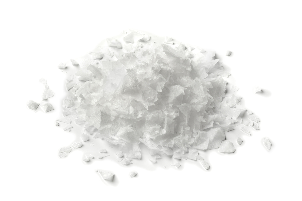 Heap Of Salt Flakes On White Background