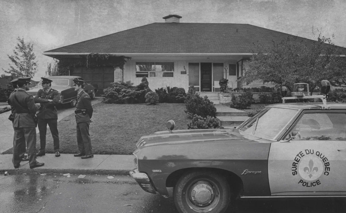 Policemen talk in front of the residence of Quebec Labour Minister Pierre Laporte in Saint-Lambert, Quebec, on Oct. 11, 1970. Laporte was abducted the previous day as he came out of the front door of his home in the Montreal suburb. (The Canadian Press/Peter Bregg)