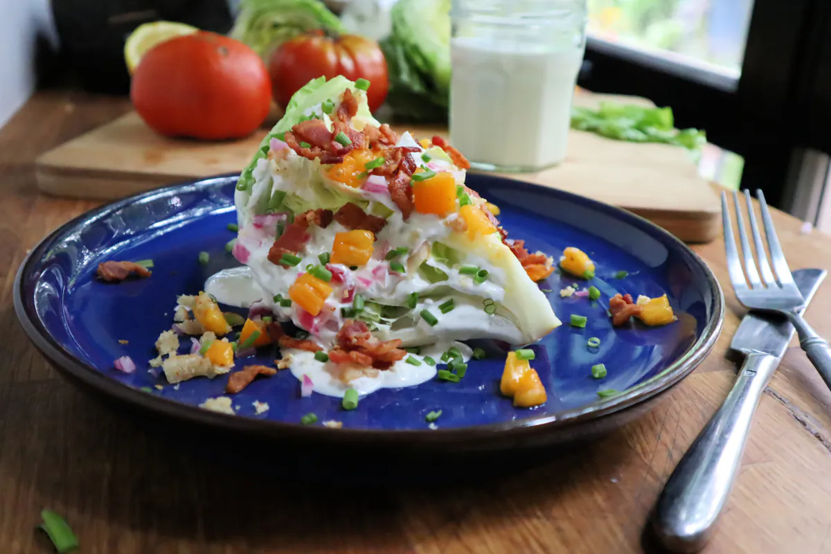 A towering iceberg wedge salad topped with crumble bacon and blue cheese dressing is a classic steakhouse side. (Gretchen McKay/Pittsburgh Post-Gazette/TNS)