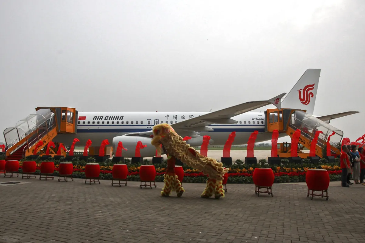 Dancers perform a lion dance near the 100th A320 airplane assembled at the Tianjin plant of Airbus in north China's Tianjin Municipality on Aug. 31, 2012. (Chinatopix Via AP)