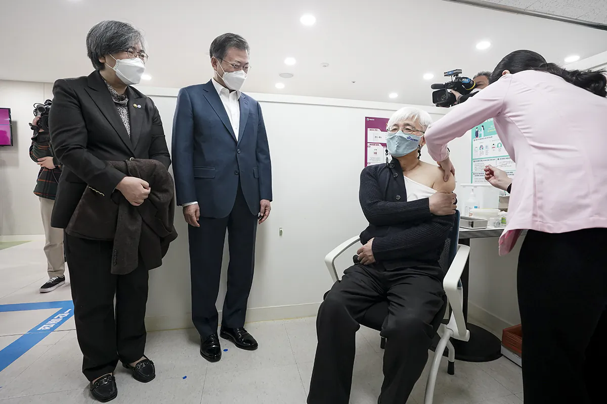 South Korean authorities watch as a person receives a COVID-19 vaccine in a file photograph. (South Korean Presidential Blue House via Getty Images)