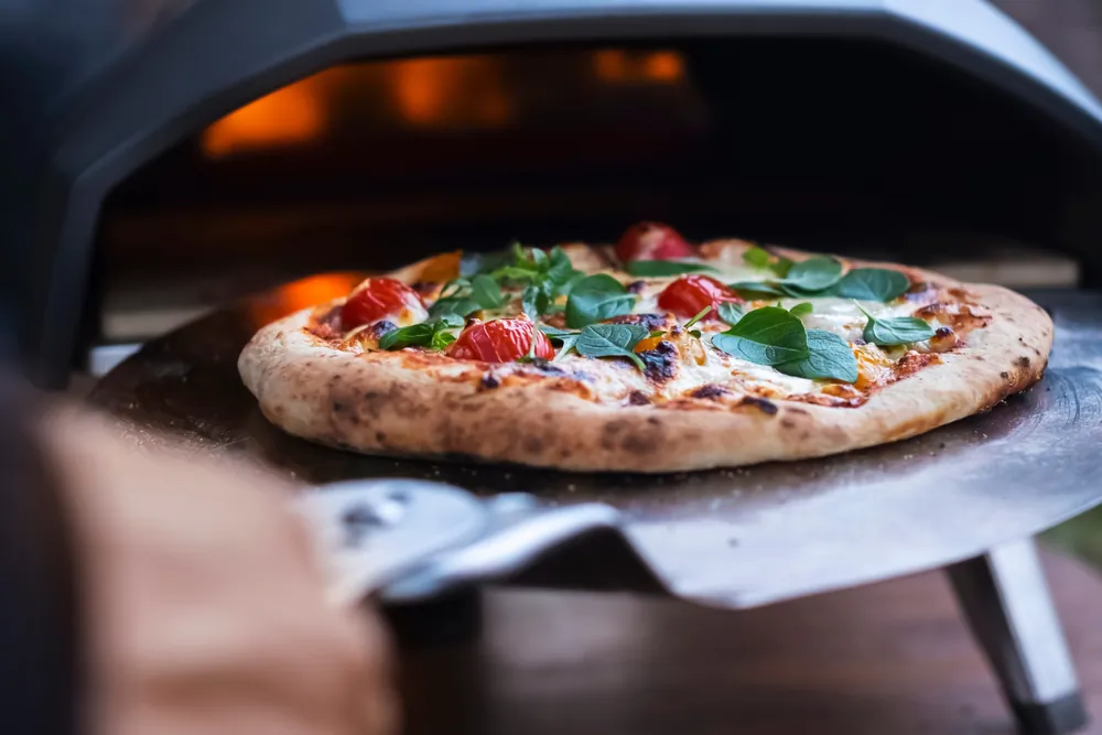 A margarita pizza with fresh basil is removed from the oven in this undated file photo. (Shutterstock)
