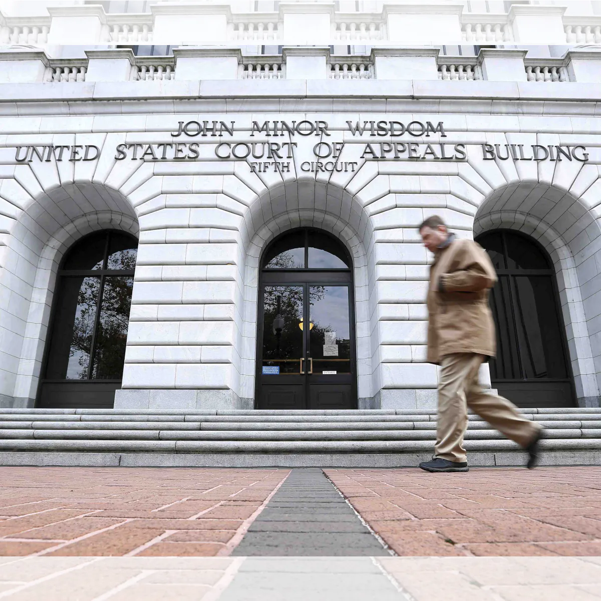 A man walks in front of the Fifth U.S. Circuit Court of Appeals, in New Orleans, La., on Jan. 7, 2015. (Jonathan Bachman/AP Photo)