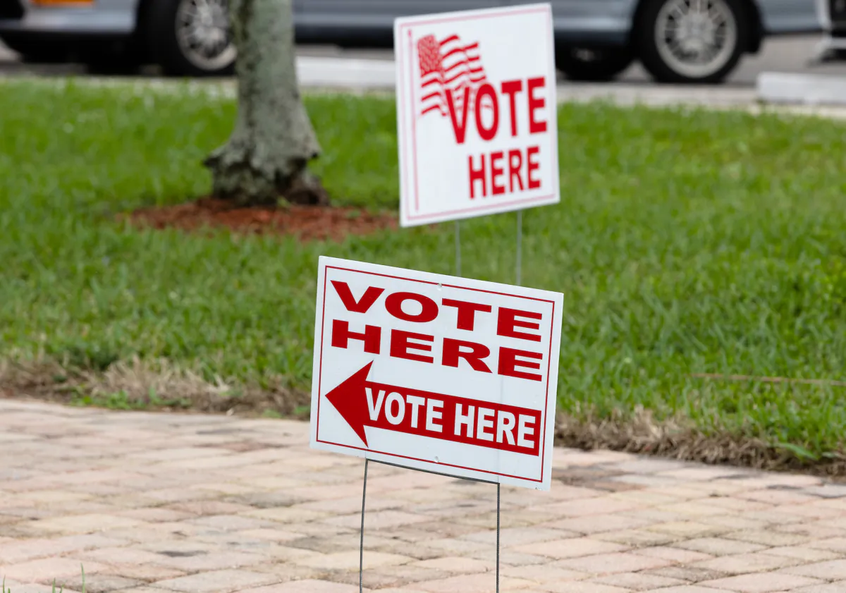 Signs outside of a polling station during the Congressional district 20 elections in Lauderhill, Florida, on Jan. 11, 2022. (Joe Raedle/Getty Images)