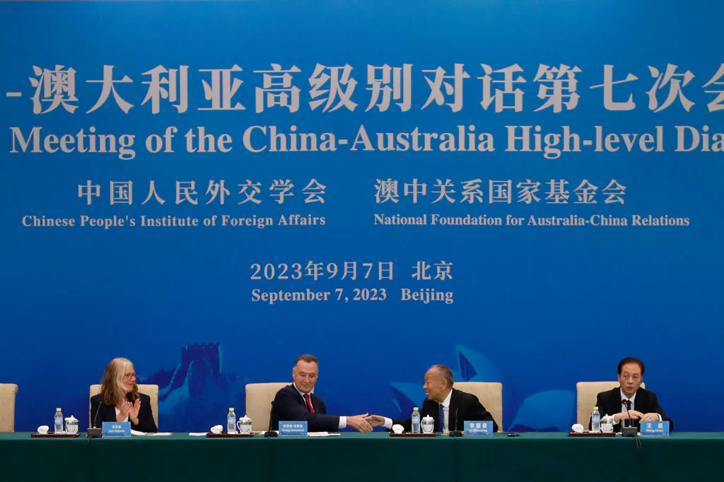 Australia's former trade minister Craig Emerson and China's former foreign minister Li Zhaoxing shake hands at the 7th China-Australia High Level Dialogue at the Diaoyutai State Guesthouse in Beijing, on Sept. 7, 2023. (Florence Lo/pool/AFP via Getty Images)
