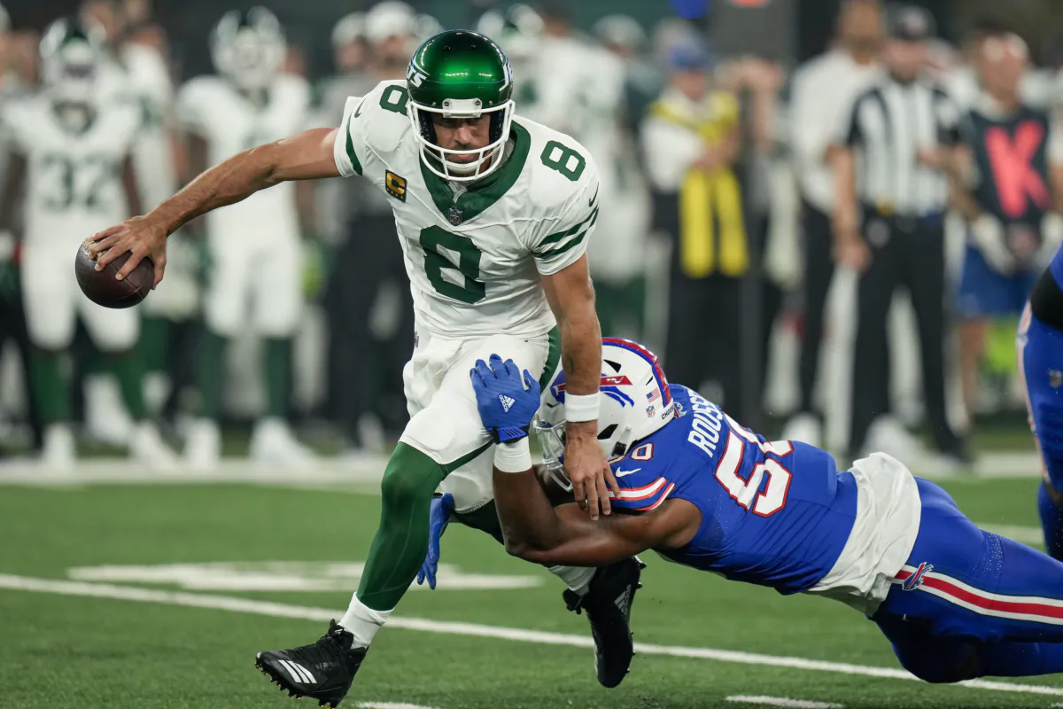 New York Jets quarterback Aaron Rodgers (8) avoids a sack from Buffalo Bills defensive end Greg Rousseau (50) during the first quarter of an NFL football game in East Rutherford, N.J., on Sept. 11, 2023. (Seth Wenig/AP Photo)