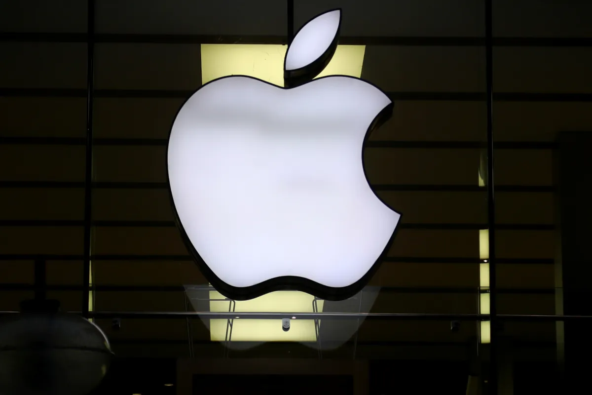 The Apple logo is illuminated at a store in the city center of Munich on Dec. 16, 2020. (Matthias Schrader/AP Photo)