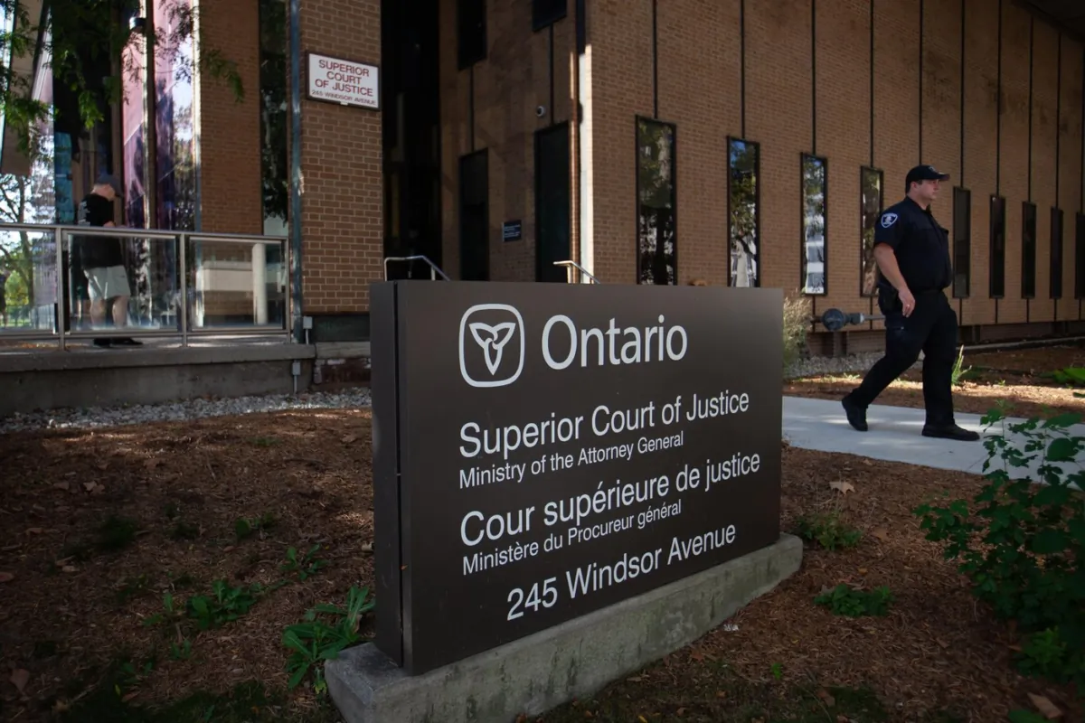 A police officer is seen outside Superior Court in Windsor, Ont., on day one of the trial of a man facing terror-related murder charges in the 2021 deaths of four members of a Muslim family, on Sept.5, 2023. (The Canadian Press/Dax Melmer)