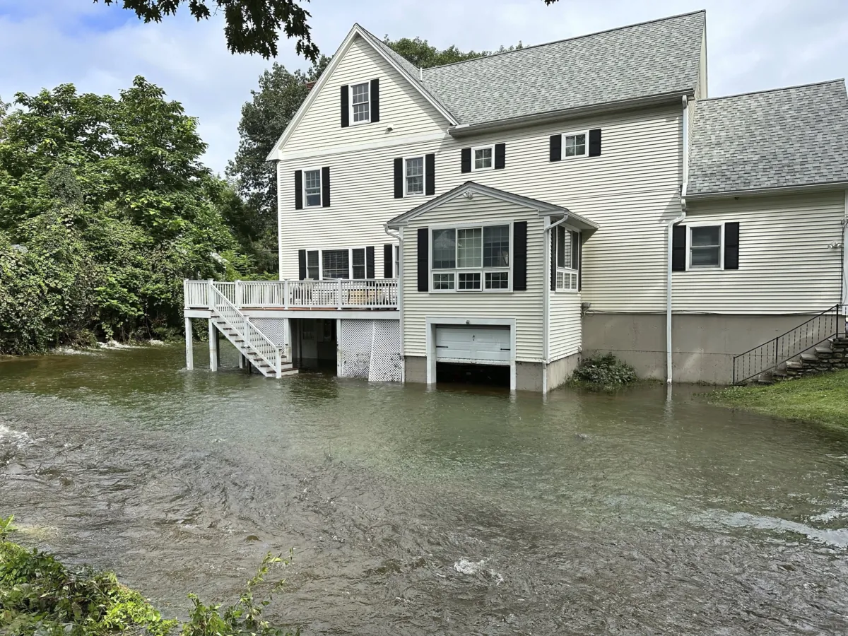 A brook overflows into the garage of a home following heavy rains overnight in Leominster, Mass., on Sept. 12, 2023. (Michael Casey/AP Photo)
