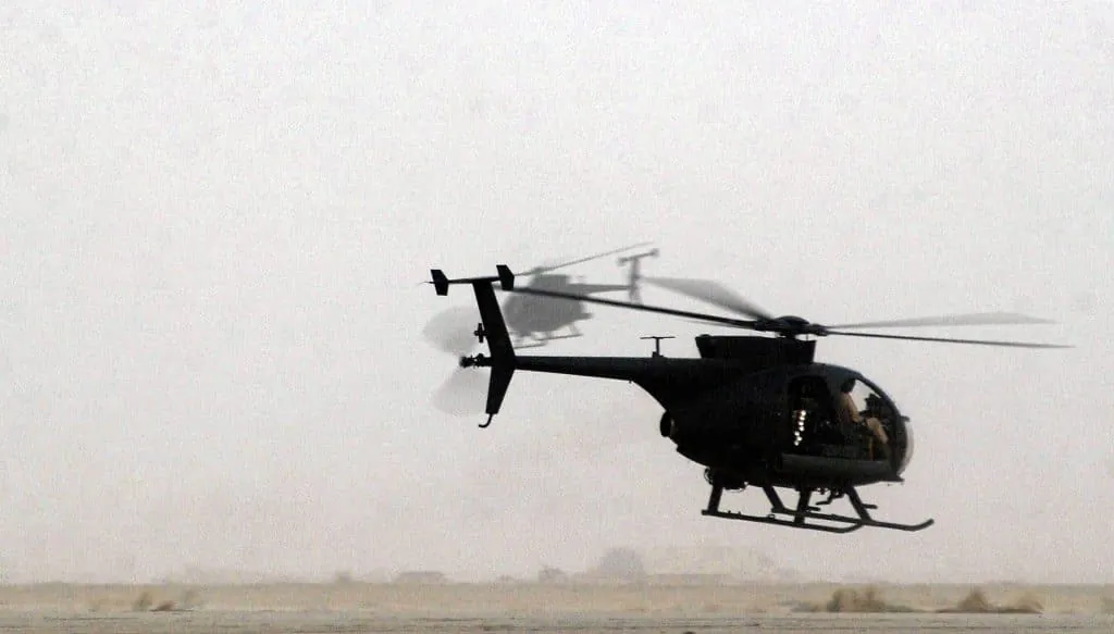 Two US Army (USA) AH-6J Little Bird helicopters take off for a mission at a forward deployed location in southern Iraq during Operation Iraqi Freedom. (SSgt Steve Cuomo, USAF)