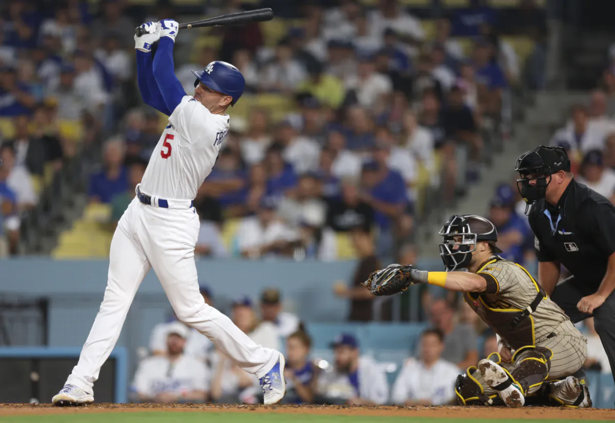 Freddie Freeman (5) of the Los Angeles Dodgers hits a two run home run in front of Brett Sullivan (29) of the San Diego Padres and umpire Jeremy Riggs, to take a 3–0 lead, during the third inning at Dodger Stadium in Los Angeles on Sept. 12, 2023. (Harry How/Getty Images)