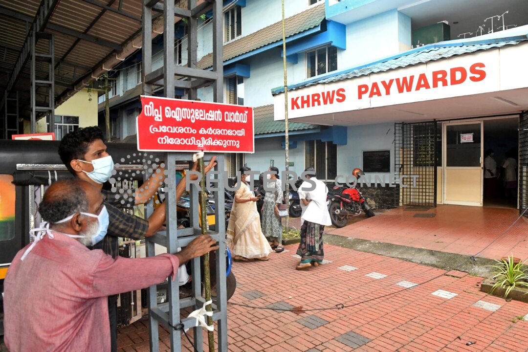 Staff members install a sign reading "Nipah isolation ward, entry strictly prohibited" at a hospital where a ward is being prepared for suspected Nipah virus patients in Kozhikode district, Kerala, India, on Sept. 12, 2023. (Stringer/Reuters)
