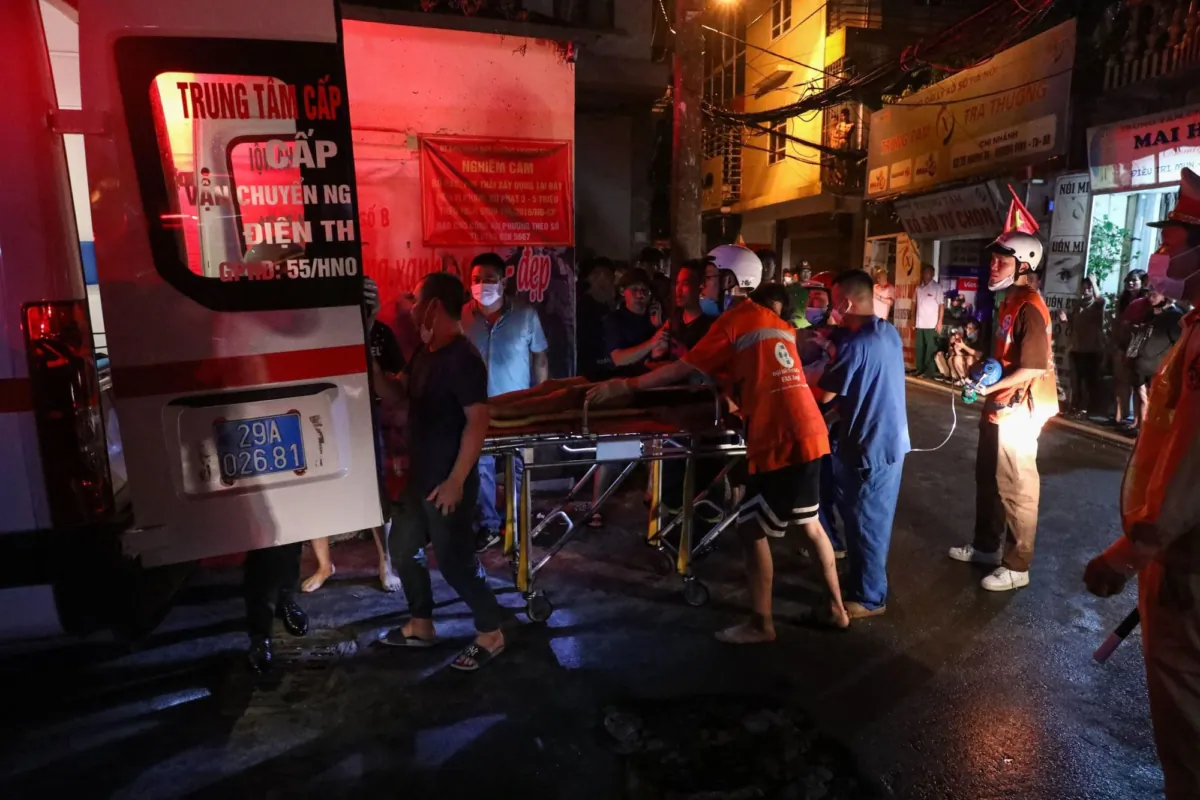 Rescue workers transport a victim to hospital following a major fire at an apartment block in Hanoi on Sept. 13, 2023. (Le Phu/AFP via Getty Images)